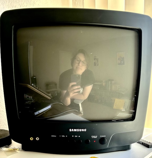 a picture of a real cutie patootie. it's their reflection in a panasonic crt tv